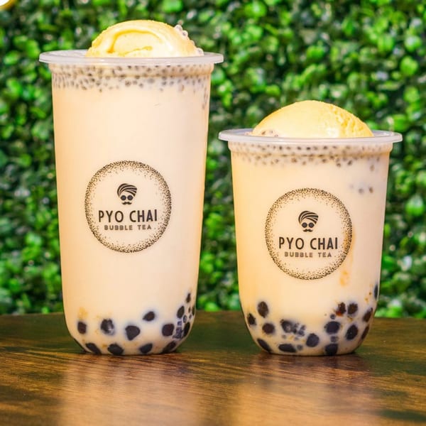 Two PYO Chai bubble teas with boba, chia seeds, and a scoop of ice cream.